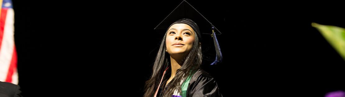 Student wearing cap and gown at PCC graduation